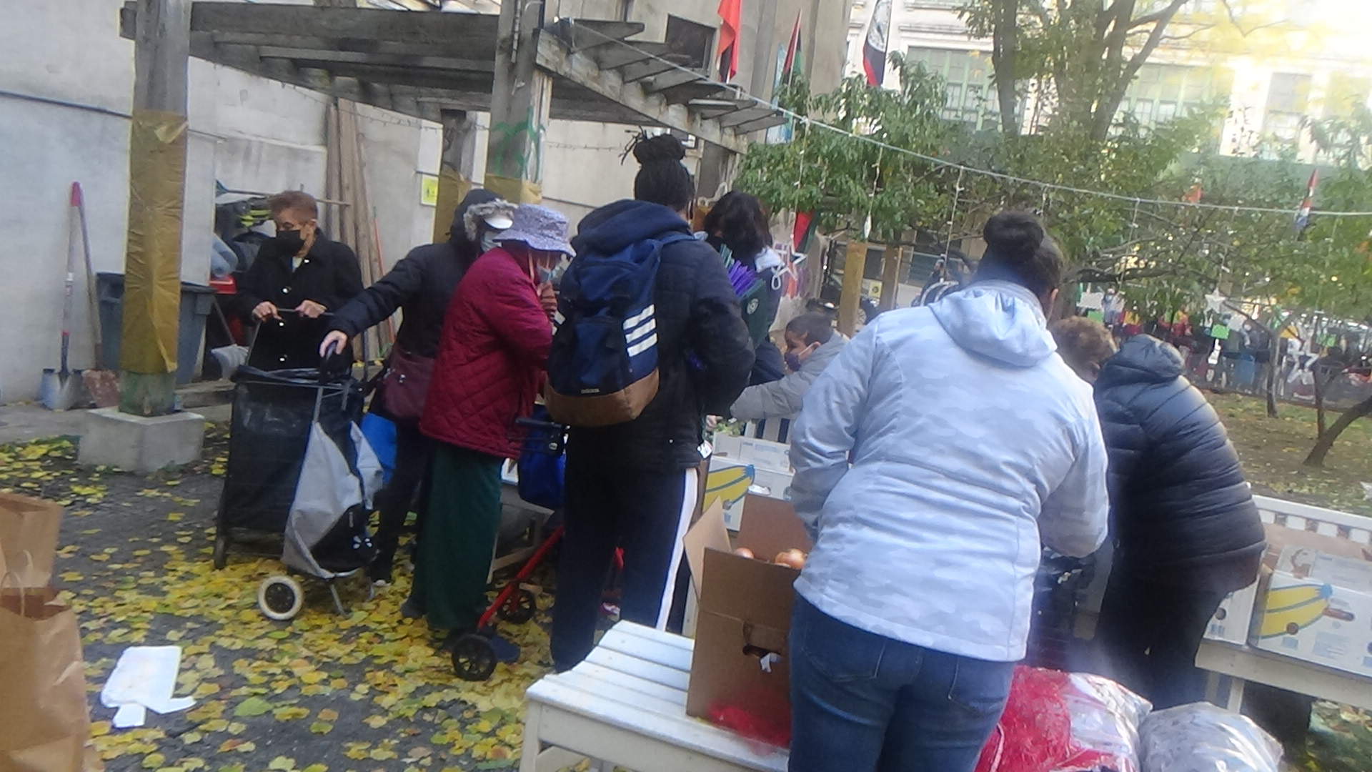 People gathered around benches and boxes during a winter distribution event